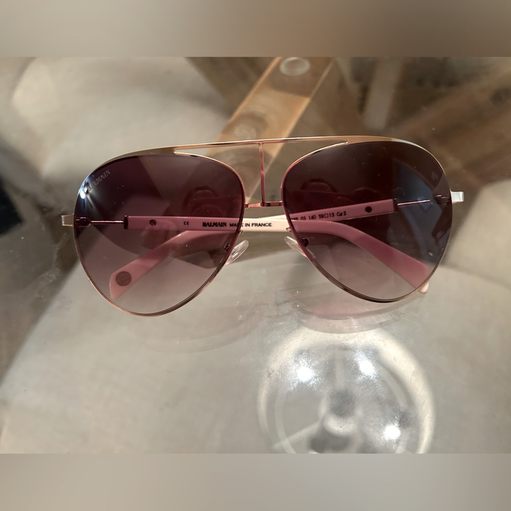 Balmain sunglasses. Ivory arms with brown lenses and gold metal framing.